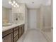 Bright bathroom with dual sinks, granite countertops, and a glass-enclosed shower at 1189 Hillside Peak St, Henderson, NV 89002