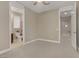 Bedroom features carpet, access to the ensuite bathroom, and neutral walls at 1189 Hillside Peak St, Henderson, NV 89002