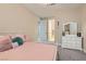 Cozy bedroom features plush pillows, a white dresser, and neutral decor at 1189 Hillside Peak St, Henderson, NV 89002