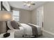 Virtually staged bedroom with carpet, neutral walls, ceiling fan and an adjacent bathroom at 1189 Hillside Peak St, Henderson, NV 89002
