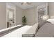 Virtually staged bedroom features carpet, ceiling fan, and entry to the bathroom at 1189 Hillside Peak St, Henderson, NV 89002