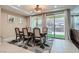 Elegant dining room featuring a stylish chandelier, patio access and a decorative rug at 1189 Hillside Peak St, Henderson, NV 89002