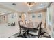 Well-lit dining room with modern chandelier, decorative accents, and ample seating at 1189 Hillside Peak St, Henderson, NV 89002