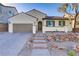 Charming single-story home featuring desert landscaping, neutral colors, and a tile roof at 1189 Hillside Peak St, Henderson, NV 89002