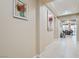 Inviting hallway featuring neutral walls, decorative art and tile flooring leading to the dining area at 1189 Hillside Peak St, Henderson, NV 89002