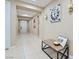 Entry hallway features light tile floors, a wooden bench, decorative wall clock and front door access at 1189 Hillside Peak St, Henderson, NV 89002