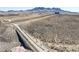 Desert landscape with distant mountain views and access road at 1189 Hillside Peak St, Henderson, NV 89002