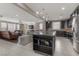 Open-concept living space featuring a kitchen island, dining area, and living room with great natural light at 1189 Hillside Peak St, Henderson, NV 89002