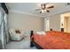 Bright primary bedroom with chair, fan, and a view of the ensuite bathroom at 1189 Hillside Peak St, Henderson, NV 89002