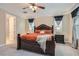 Spacious main bedroom with a large bed, ceiling fan, and tray ceiling for a luxurious feel at 1189 Hillside Peak St, Henderson, NV 89002
