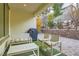 Covered patio featuring modern seating, a built-in grill, and a view of the landscaped backyard at 1189 Hillside Peak St, Henderson, NV 89002