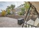 Paver patio featuring a swing seat and built-in fire pit at 1189 Hillside Peak St, Henderson, NV 89002