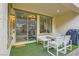 Exterior view of a covered patio with modern seating and a view of the landscaped backyard at 1189 Hillside Peak St, Henderson, NV 89002