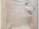 Bright shower with a glass door, tiled walls, bench, and shower head with handheld wand at 1189 Hillside Peak St, Henderson, NV 89002