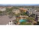 Aerial view showcases community pools, lush landscaping, and neighboring residences at 120 Los Cabos Dr # 301, Las Vegas, NV 89144