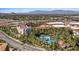 Aerial shot of resort-style pools and landscaping surrounded by multiple buildings and lush greenery at 120 Los Cabos Dr # 301, Las Vegas, NV 89144