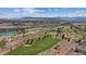 Scenic aerial view of lush green golf course, a pond, and distant mountains at 120 Los Cabos Dr # 301, Las Vegas, NV 89144
