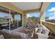 Open-air balcony with neutral color palette and wood coffee table, extending living space at 120 Los Cabos Dr # 301, Las Vegas, NV 89144