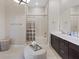 Bright bathroom with modern finishes, dual sinks, decorative ottoman, and a shower-tub combination at 120 Los Cabos Dr # 301, Las Vegas, NV 89144