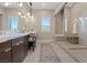 Neutral bathroom features a vanity with a chair and a spacious, tiled shower with a glass enclosure at 120 Los Cabos Dr # 301, Las Vegas, NV 89144