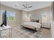 Neutral bedroom offers a spacious layout, ceiling fan, and large windows with stylish window treatments at 120 Los Cabos Dr # 301, Las Vegas, NV 89144