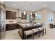 A modern kitchen features an island with bar stool seating and stainless steel appliances at 120 Los Cabos Dr # 301, Las Vegas, NV 89144