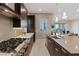 Gourmet kitchen featuring modern appliances, a large island, sleek countertops, and stylish backsplash at 120 Los Cabos Dr # 301, Las Vegas, NV 89144