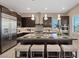Modern kitchen featuring a large central island with seating, pendant lighting, and stainless steel appliances at 120 Los Cabos Dr # 301, Las Vegas, NV 89144