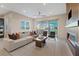 Bright living room with modern fireplace, a ceiling fan and sliding glass doors to the balcony at 120 Los Cabos Dr # 301, Las Vegas, NV 89144