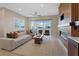 Bright living room with modern fireplace, neutral decor, comfortable seating, and sliding glass doors at 120 Los Cabos Dr # 301, Las Vegas, NV 89144