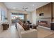 Bright living room features a modern fireplace, ceiling fan, and sliding doors to the balcony at 120 Los Cabos Dr # 301, Las Vegas, NV 89144