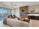 Bright living room featuring modern fireplace, stylish decor, comfortable seating, and sliding glass doors at 120 Los Cabos Dr # 301, Las Vegas, NV 89144