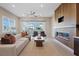 Well-lit living room with comfortable seating, fireplace, and sliding doors leading to an outdoor space at 120 Los Cabos Dr # 301, Las Vegas, NV 89144