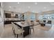 An open-concept living space combines a kitchen, dining area, and living room for modern living at 120 Los Cabos Dr # 301, Las Vegas, NV 89144