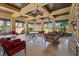 Covered patio area with stylish seating, ceiling fans, and stone fireplace provides relaxed atmosphere at 120 Los Cabos Dr # 301, Las Vegas, NV 89144