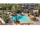 Aerial view of an outdoor pool with lounge chairs and lush greenery at 120 Los Cabos Dr # 301, Las Vegas, NV 89144