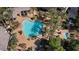 Aerial view of large pool and surrounding deck area with palm trees and lounge seating at 120 Los Cabos Dr # 301, Las Vegas, NV 89144