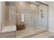 Tiled shower with a glass enclosure offers a bench seat, towel rack, and stylish finishes at 120 Los Cabos Dr # 301, Las Vegas, NV 89144