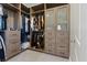 Spacious walk-in closet with custom shelving, drawers, and glass-front cabinets, providing ample storage space at 120 Los Cabos Dr # 301, Las Vegas, NV 89144