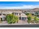 Two-story house with a three-car garage and landscaped yard at 12355 Grey Dunes Ave, Las Vegas, NV 89138