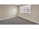 Simple bedroom with carpet and a window with blinds at 1800 Edmond St # 124, Las Vegas, NV 89146