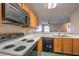 Kitchen features wood cabinets and a view of living area at 1800 Edmond St # 124, Las Vegas, NV 89146