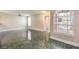 Living room with tile floor, large window, and access to other rooms at 1800 Edmond St # 124, Las Vegas, NV 89146
