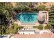 Bird's-eye view of a beautiful pool and backyard oasis with a thatched cabana at 1975 Alcova Ridge Dr, Las Vegas, NV 89135