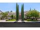 Stunning two-story home with manicured lawn and tall trees at 1975 Alcova Ridge Dr, Las Vegas, NV 89135