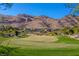 Golf course with mountain backdrop; homes in the distance at 1975 Alcova Ridge Dr, Las Vegas, NV 89135