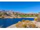Lake and golf course with mountain views and homes at 1975 Alcova Ridge Dr, Las Vegas, NV 89135