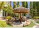 Relaxing patio seating area with a thatched umbrella at 1975 Alcova Ridge Dr, Las Vegas, NV 89135