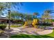 playground with a yellow slide and play area at 1975 Alcova Ridge Dr, Las Vegas, NV 89135