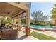 Relaxing pool area with a covered patio and lush landscaping at 1975 Alcova Ridge Dr, Las Vegas, NV 89135